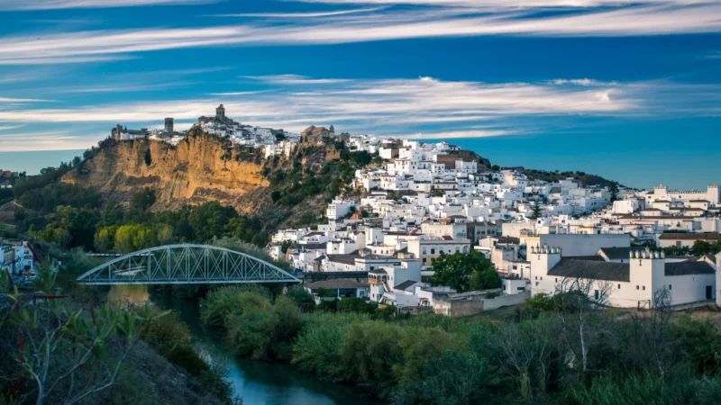 Arcos de la Frontera on its cliff above the Guadalete river at sunset, Sierra de Cádiz, Spain