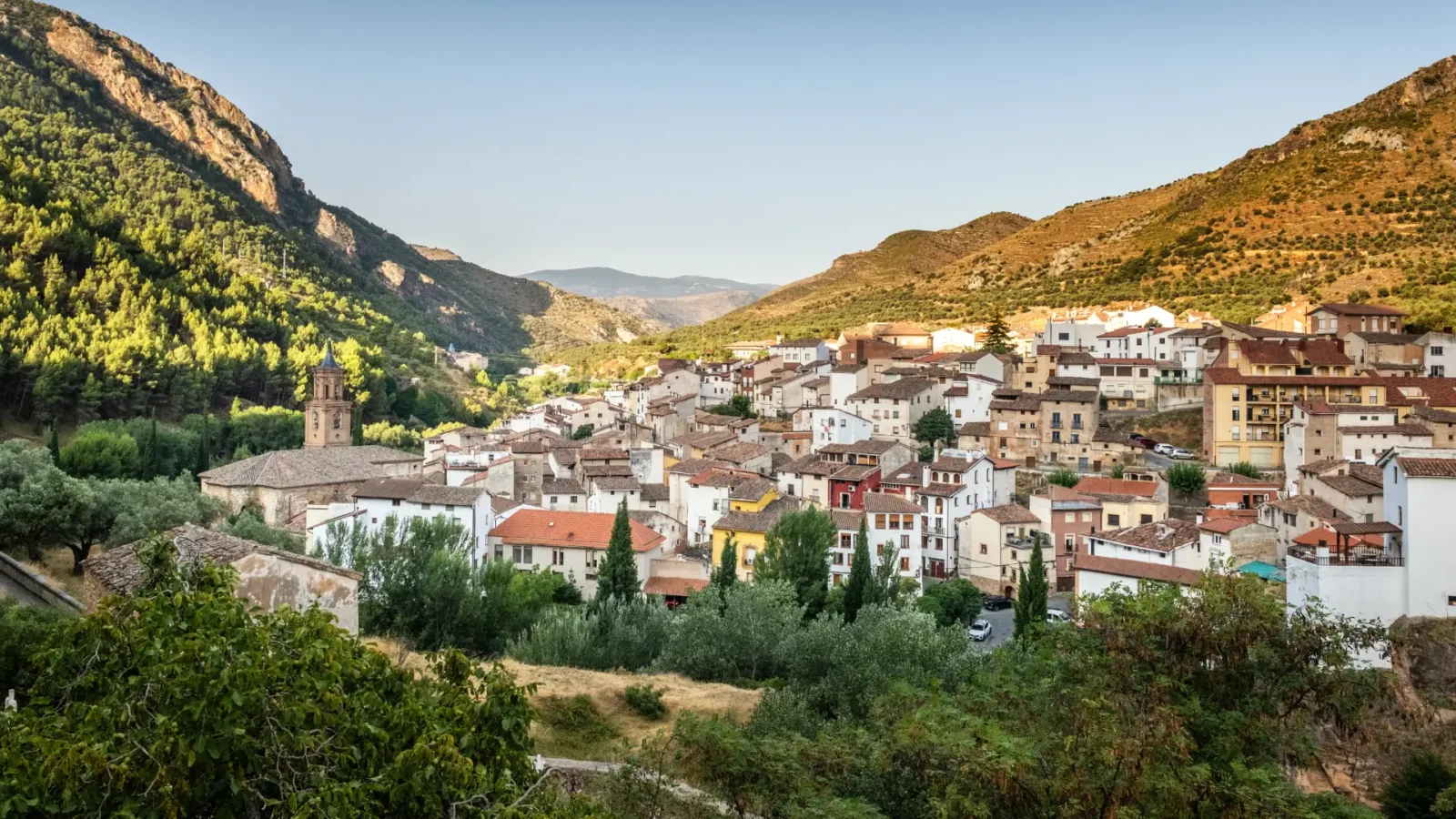 The village of Arnedillo in the narrow Cidacos valley below limestone cliffs, La Rioja, Spain