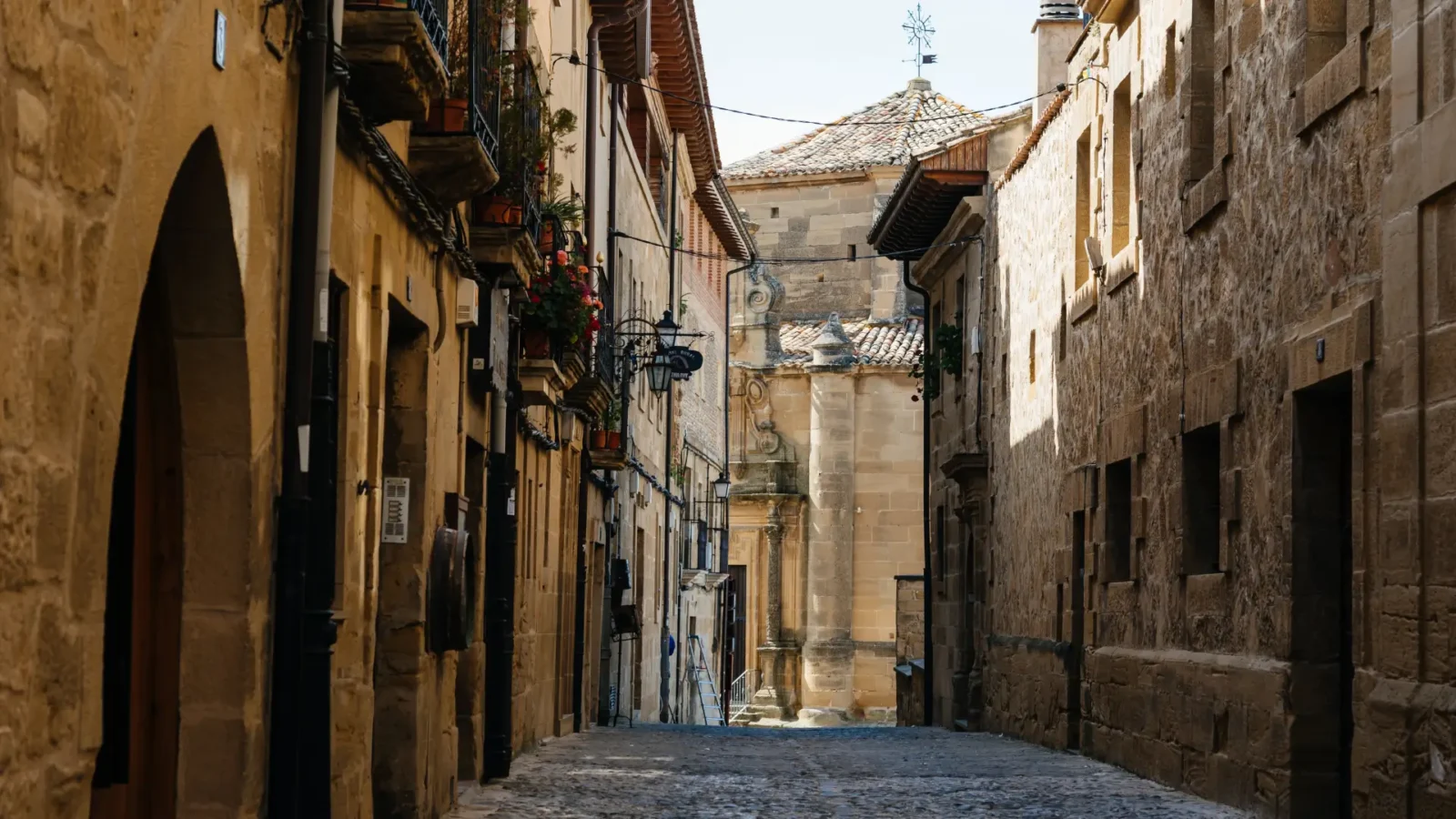 A quiet stone lane in the old town of Briones, La Rioja, Spain