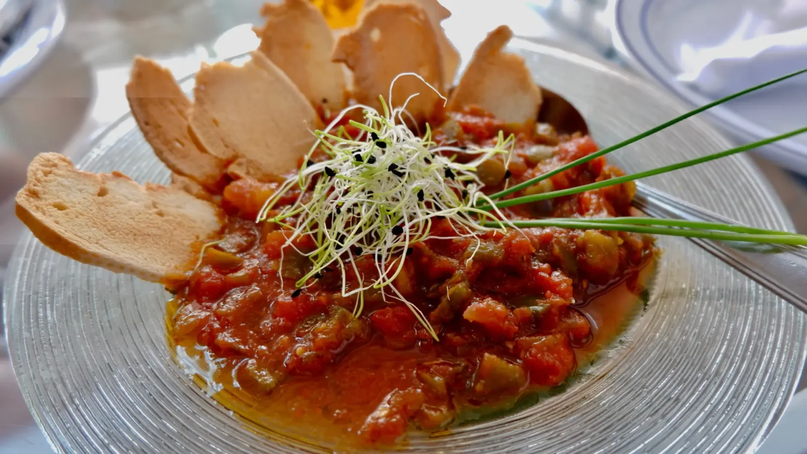 A plate of pisto manchego with garlic sprouts in Campo de Criptana, Ciudad Real, Spain