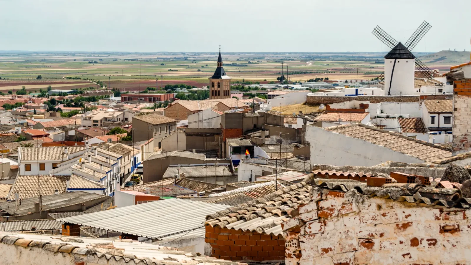 A view over the rooftops of Campo de Criptana toward the Mancha plain, Ciudad Real, Spain