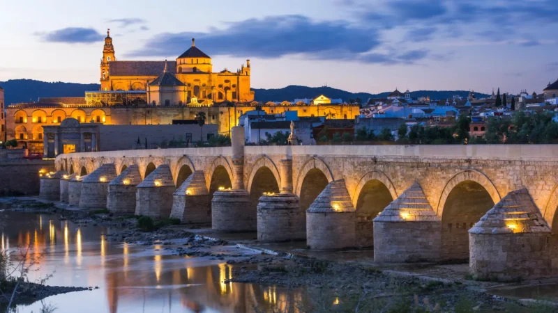 The Roman bridge and Mezquita-Catedral at dusk in Córdoba, Andalucía, Spain