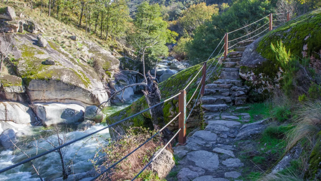 A stepped stone path with a railing running beside the river through the Garganta de los Infiernos, Jerte Valley, Extremadura, Spain