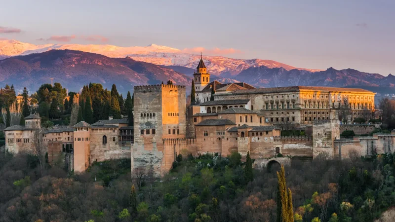 The Alhambra against the Sierra Nevada at sunset in Granada, Andalucía, Spain