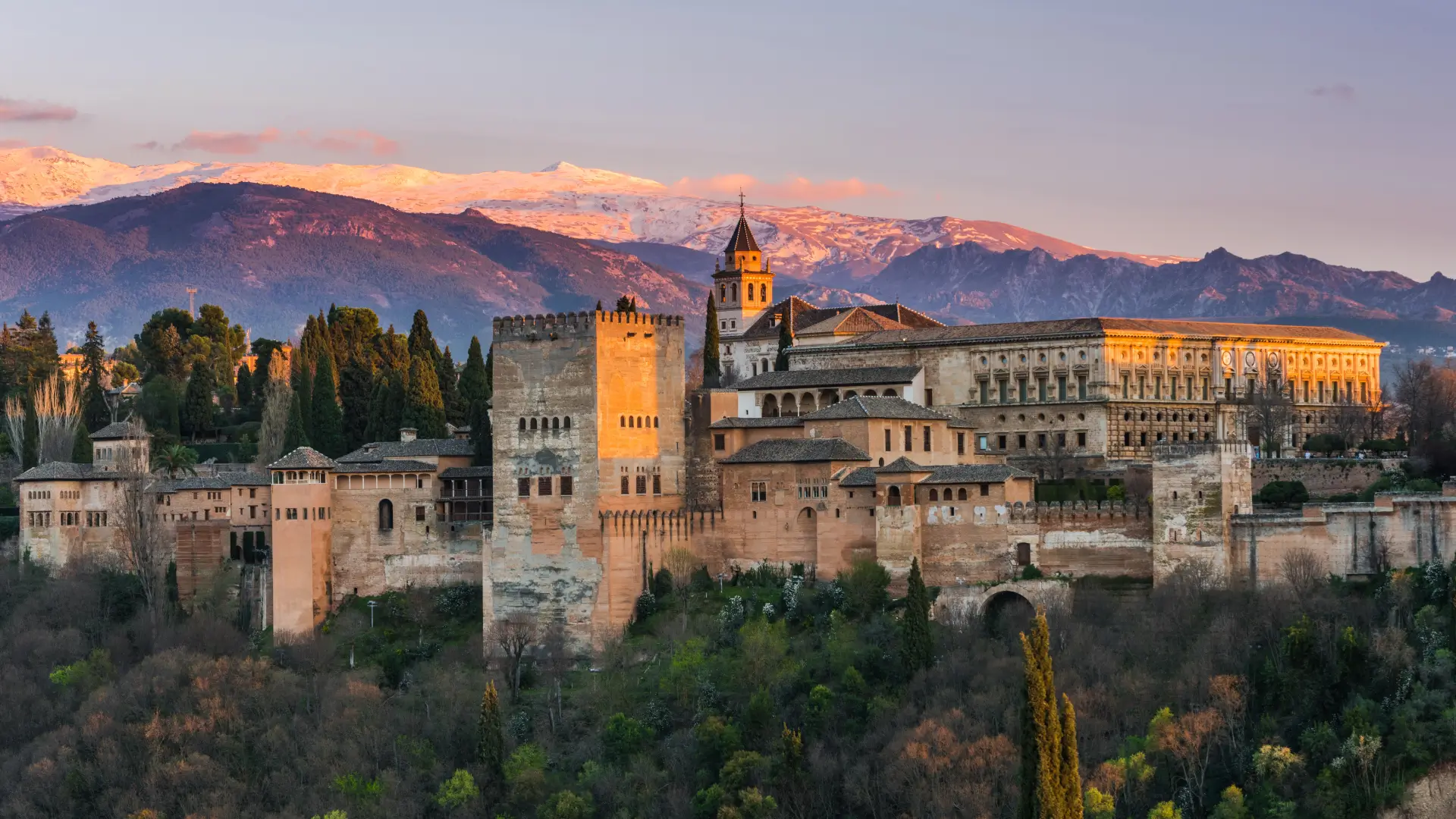 The Alhambra against the Sierra Nevada at sunset in Granada, Andalucía, Spain