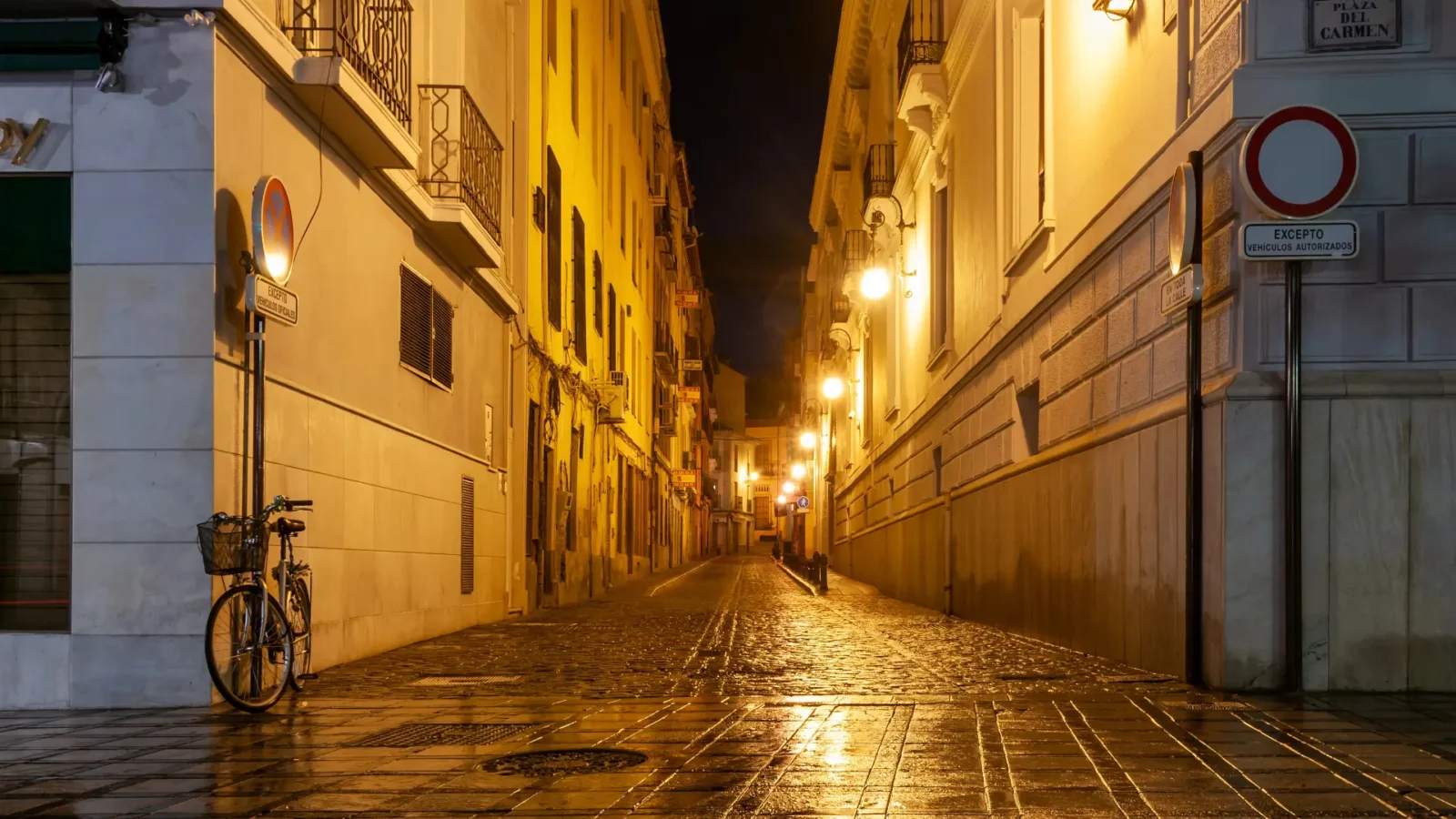 A lamplit lane in the Albaicín at night in Granada, Andalucía, Spain