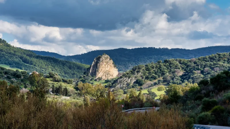 A rocky crag in the green hills of the Sierra de Grazalema Natural Park, Cádiz, Spain