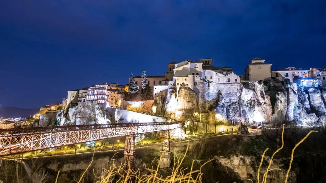 The hanging houses and the San Pablo bridge lit at night in Cuenca, Castilla-La Mancha, Spain