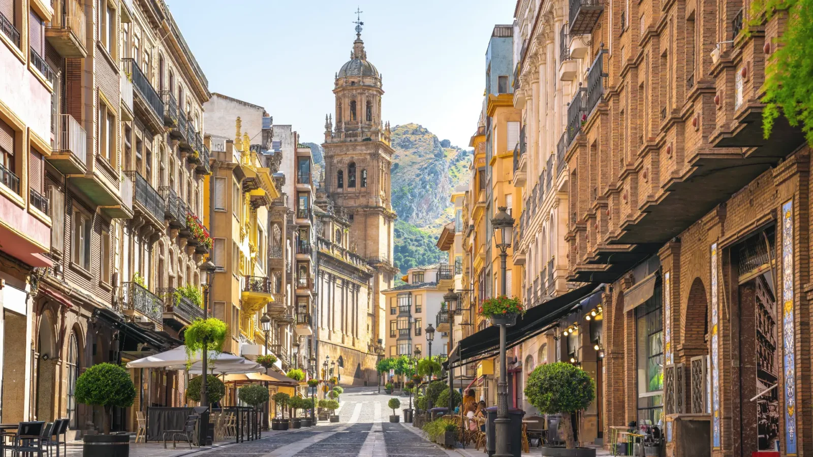 Old-town street looking to the cathedral tower and mountains in Jaén, Andalucía, Spain