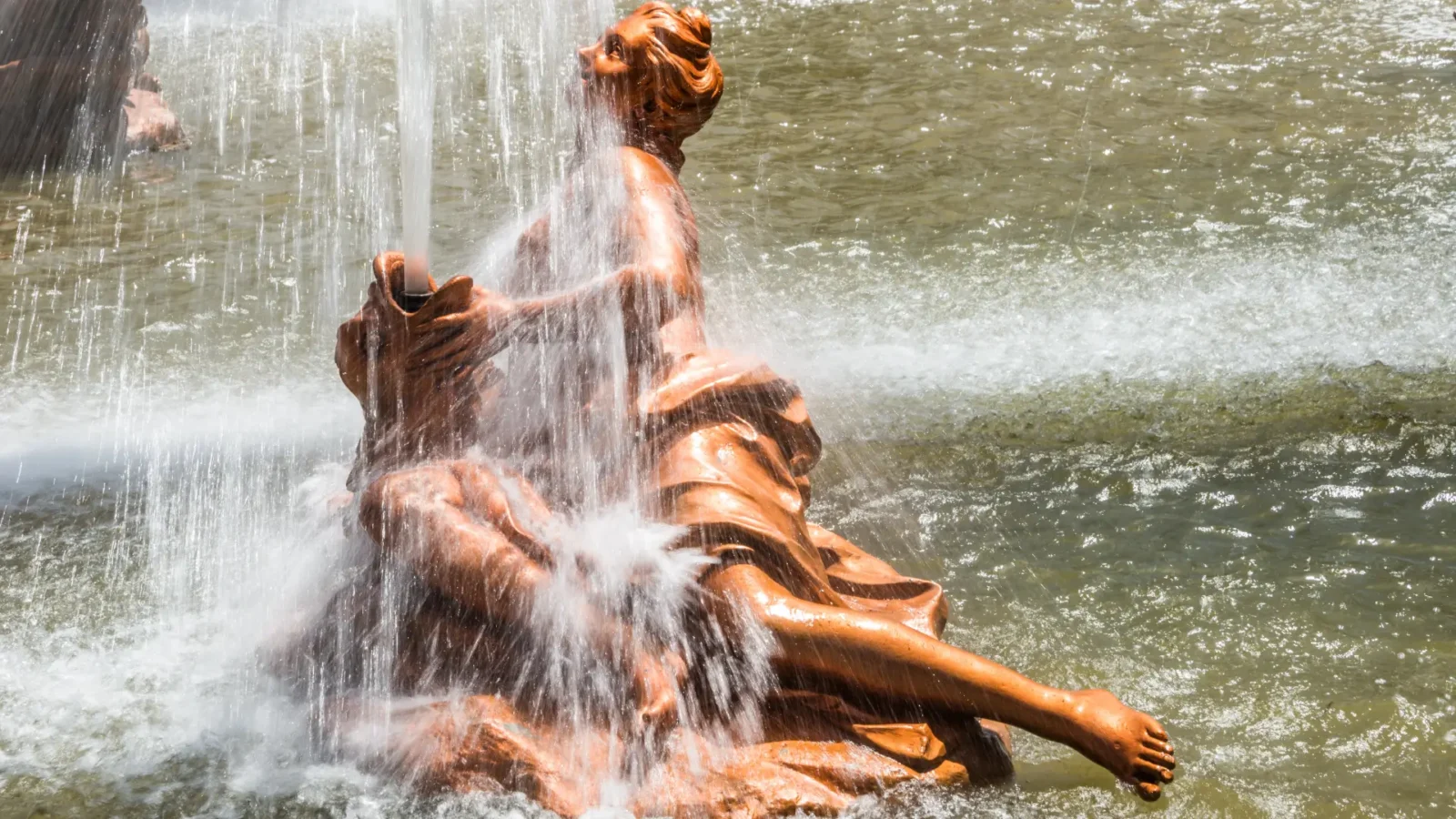 A monumental bronze fountain in full flow in the gardens of La Granja de San Ildefonso, Castilla y León, Spain