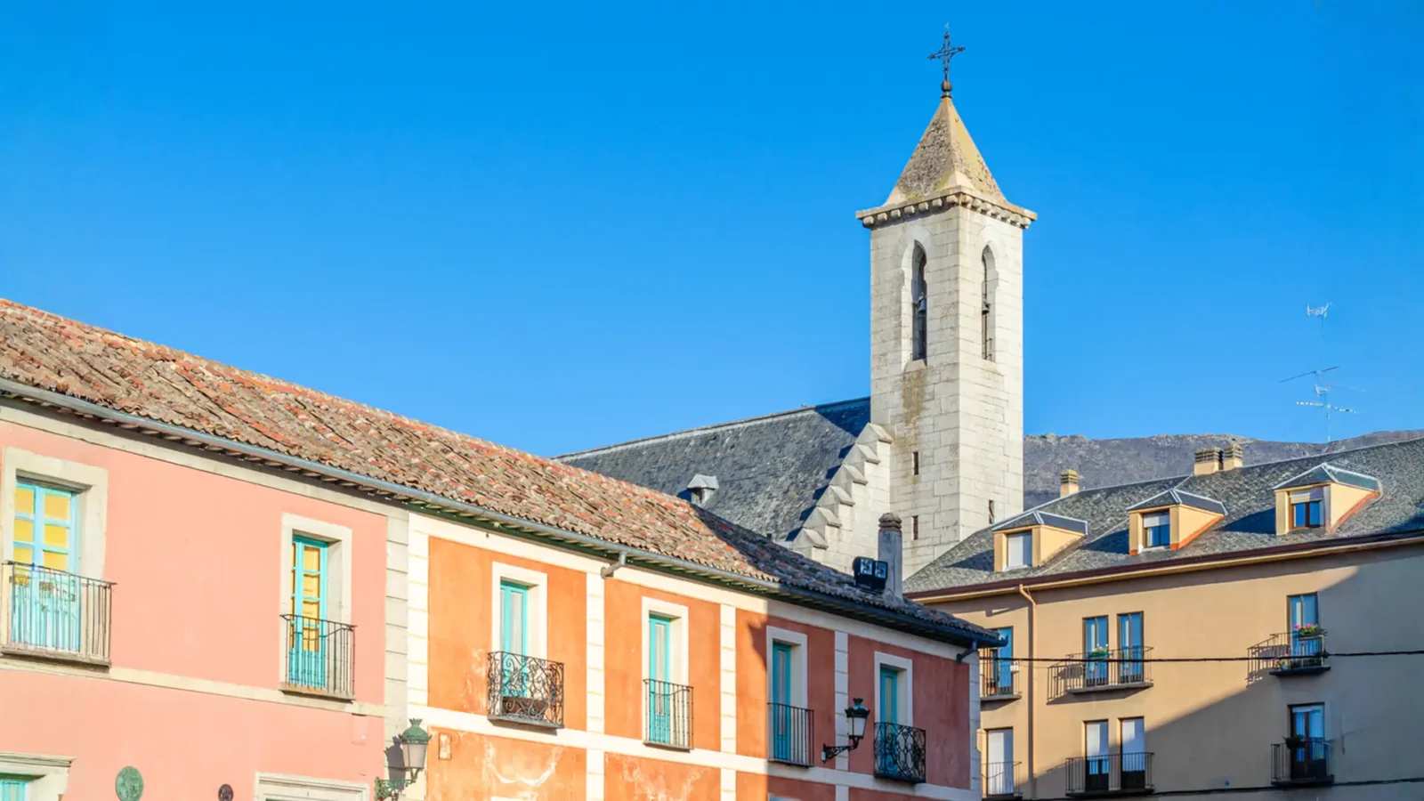 Village houses and the church tower in La Granja de San Ildefonso, Castilla y León, Spain