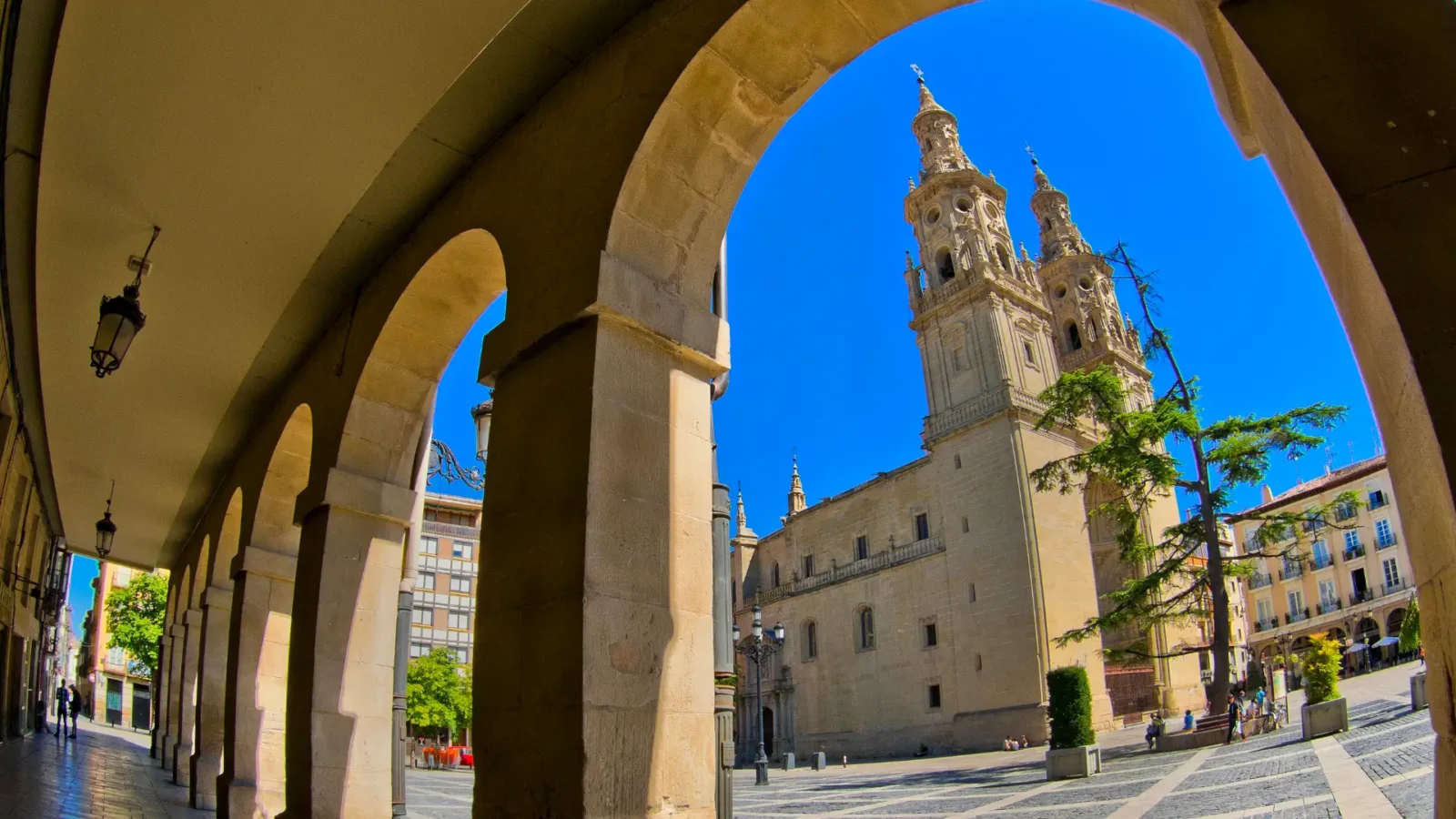 Twin towers of the Concatedral de Santa María de la Redonda seen through the arcades in Logroño, La Rioja, Spain