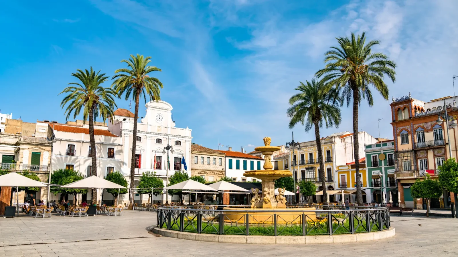 Plaza de España with its fountain and palm trees in Mérida, Extremadura, Spain