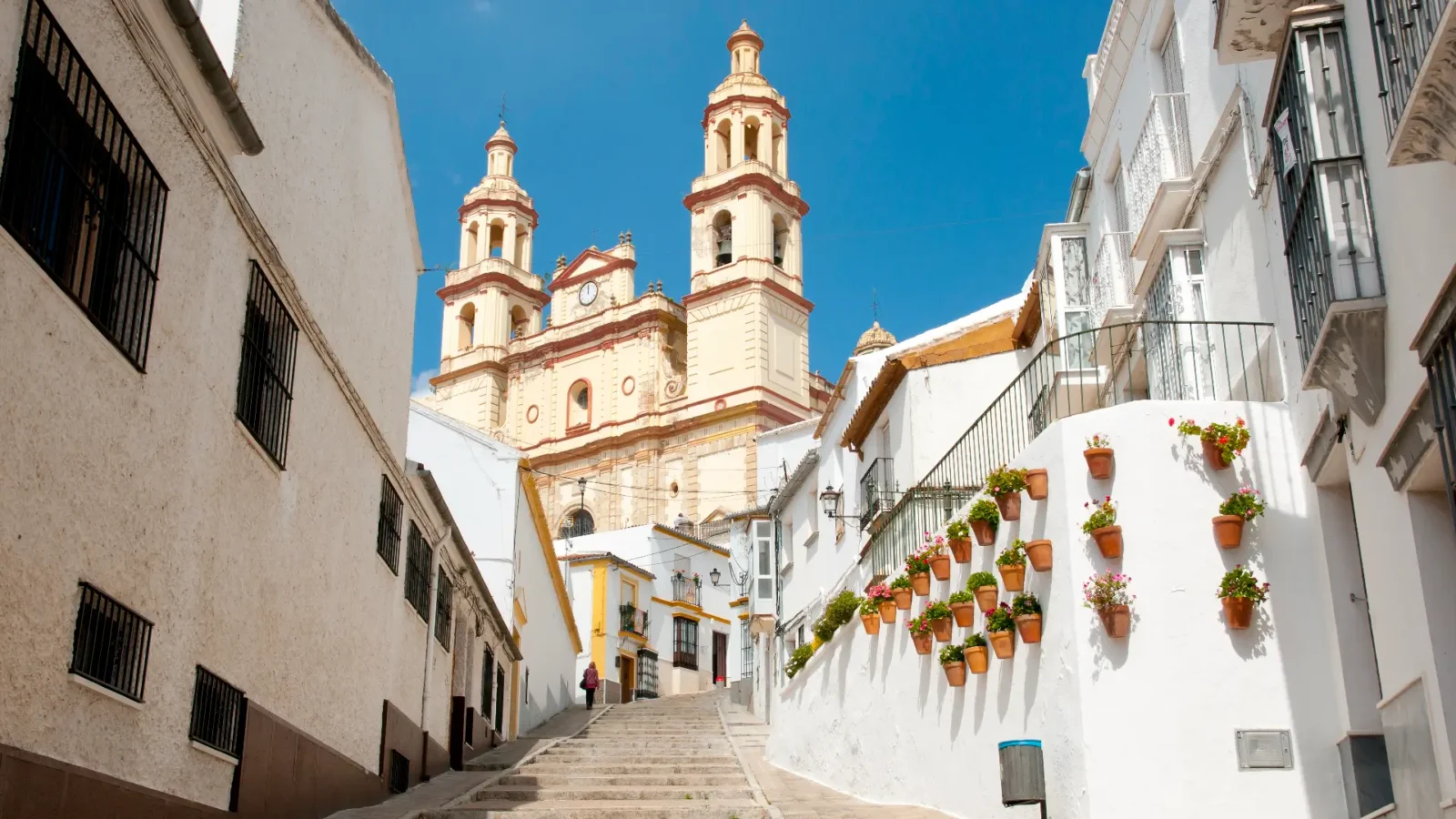 A stepped street below the church towers in the old town of Olvera, Andalucía, Spain