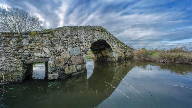 Medieval stone bridge on the old Ruta de la Plata near Aldea del Cano, Cáceres, Extremadura, Spain