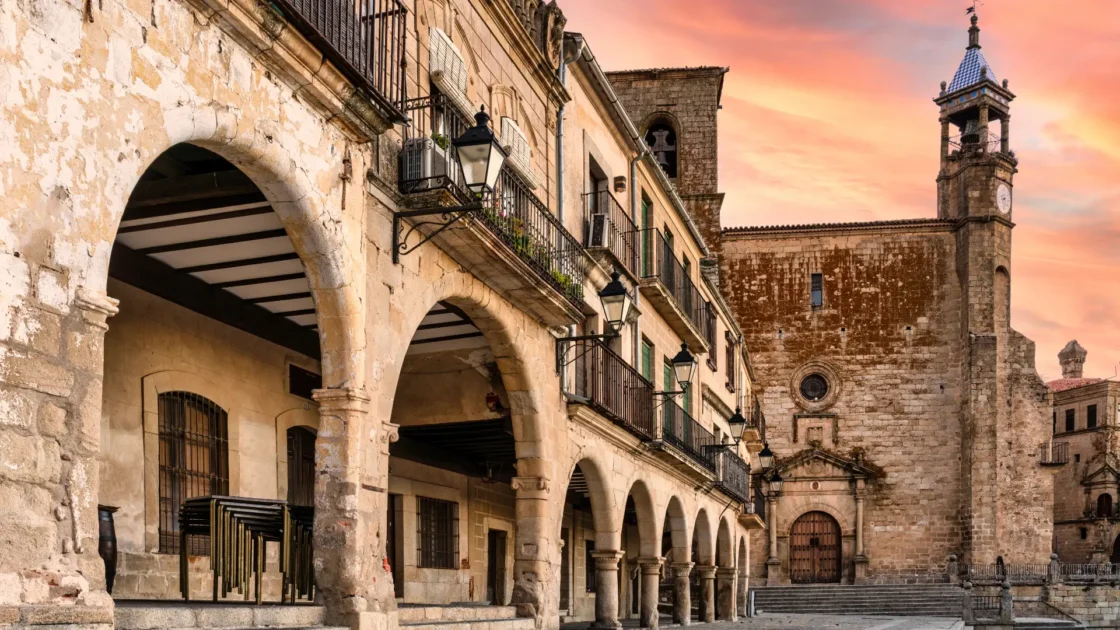 The Plaza Mayor of Trujillo at dusk seen through the arcades, Extremadura, Spain