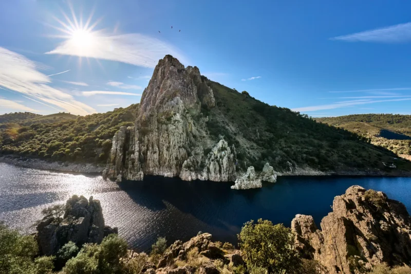 The Salto del Gitano rock rising above the Tajo river in Monfragüe National Park, with vultures circling above