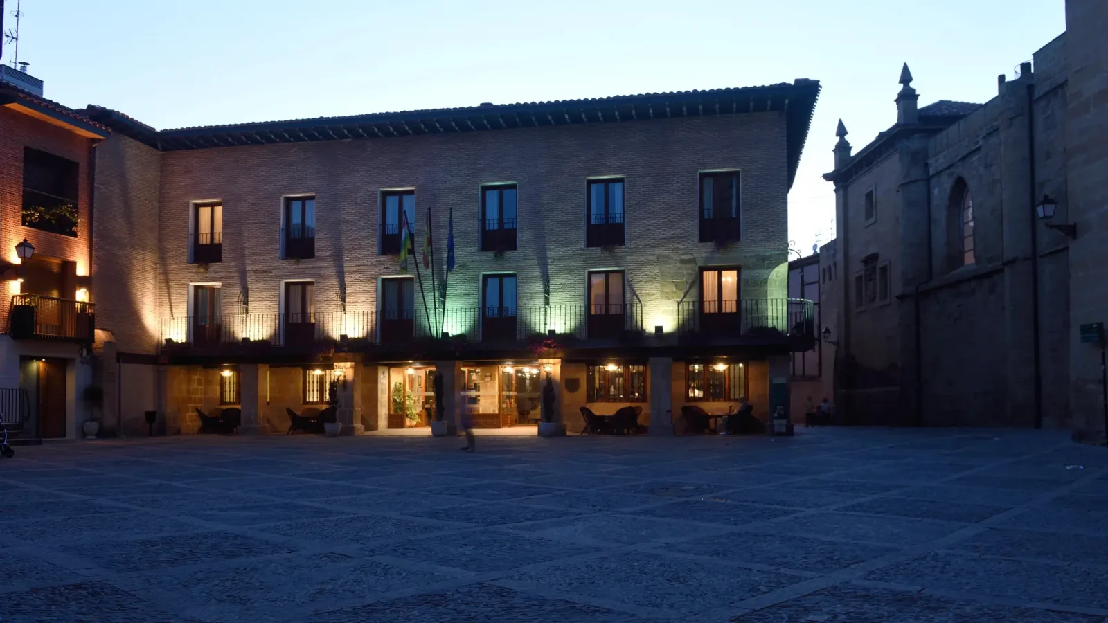 Parador on the arcaded square lit at dusk in Santo Domingo de la Calzada, La Rioja, Spain