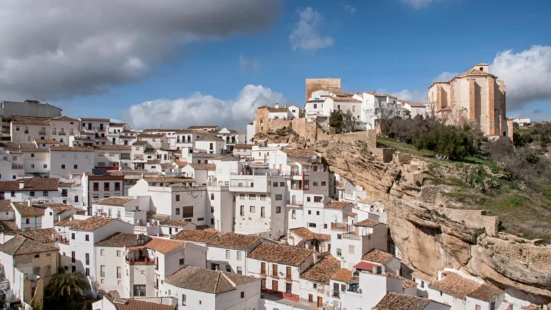 Panorama of the white houses, the tower and the church in Setenil de las Bodegas, Andalucía, Spain