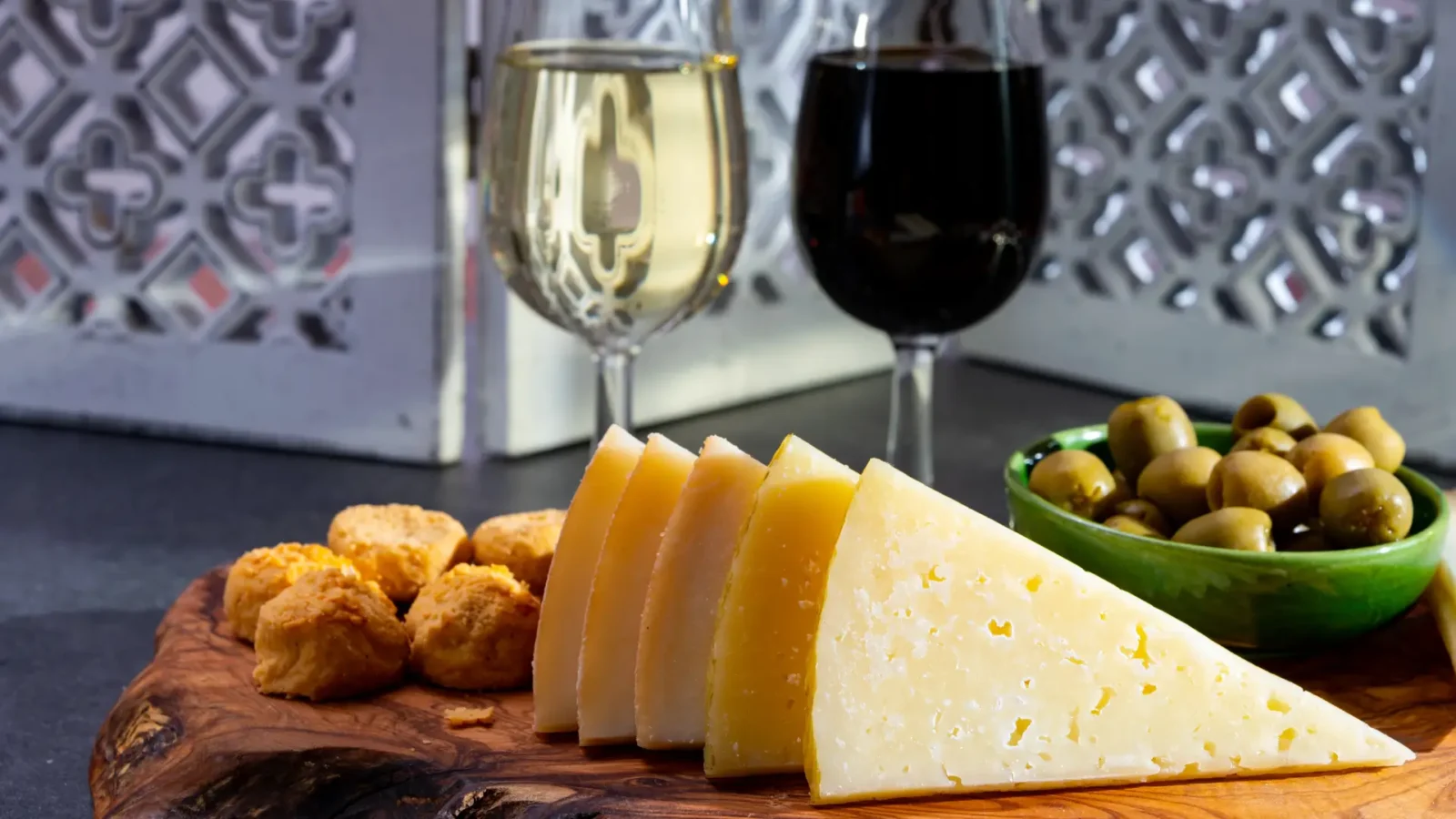 Spanish cheese, olives and wine on a wooden board — a Sierra de Cádiz tapas spread