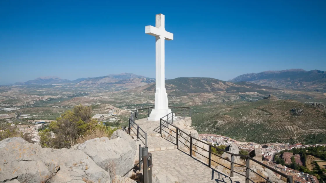 The Cruz de Santa Catalina above the olive plain and mountains in Jaén, Andalucía, Spain