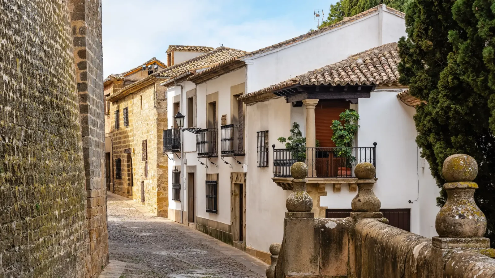 A quiet cobbled street of golden-stone Renaissance houses in Baeza, Jaén, Andalucía, Spain