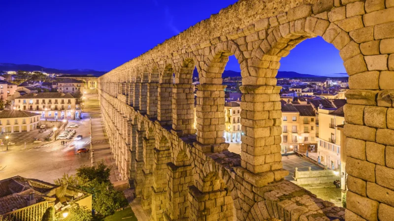 The Roman aqueduct at dusk on the Three Walled Cities route, Segovia, Castilla y León, Spain