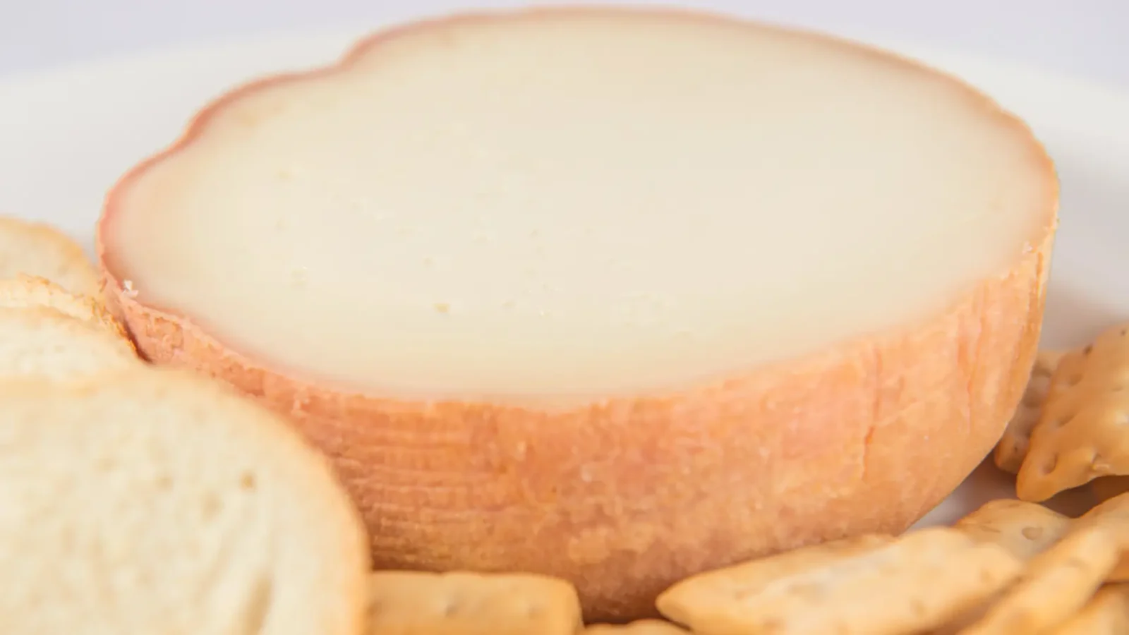A Torta del Casar, the creamy soft sheep's-milk cheese of Extremadura, served with bread and crackers