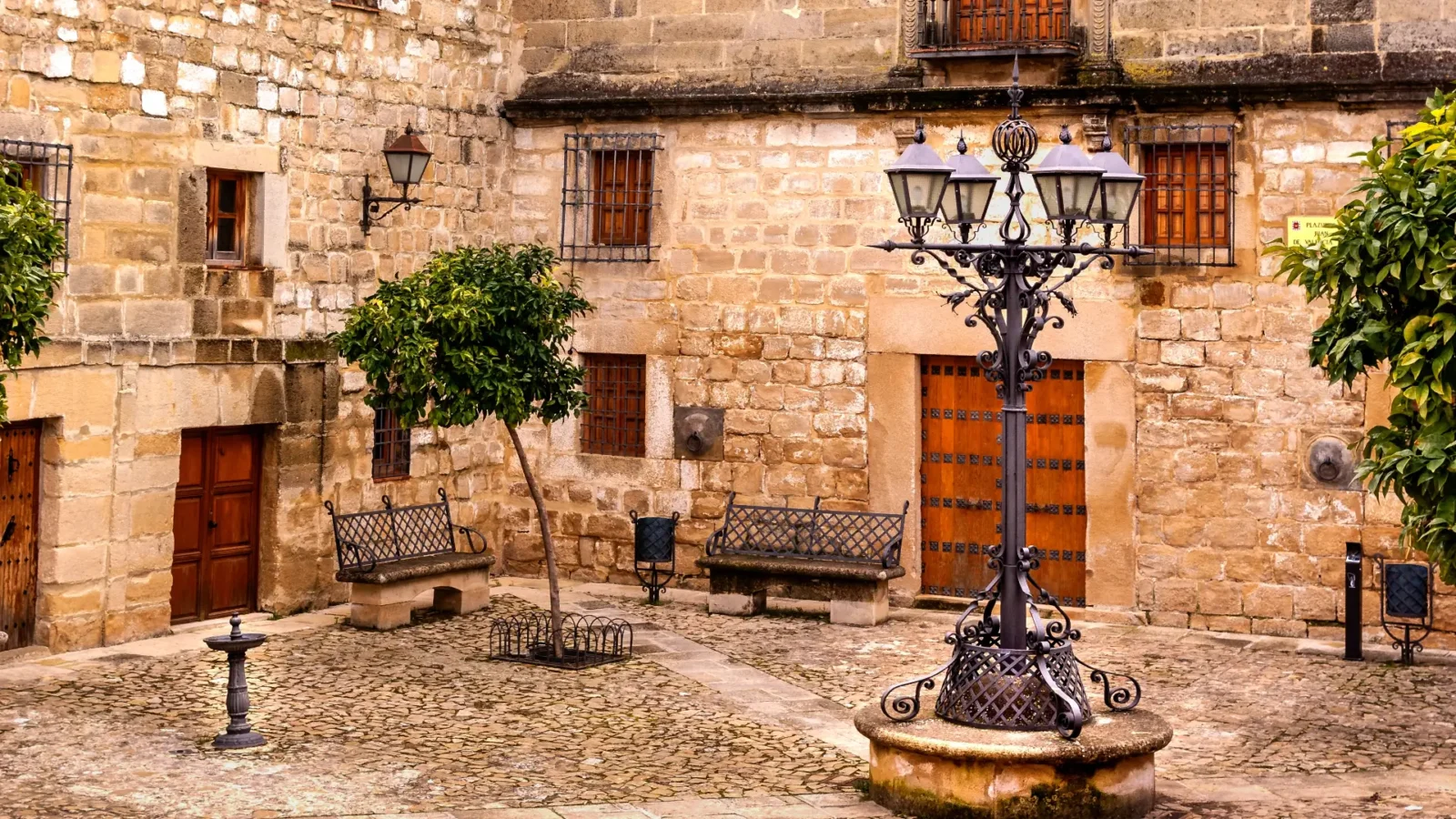 Golden-stone square with a wrought-iron lamp in the old town of Úbeda, Andalucía, Spain
