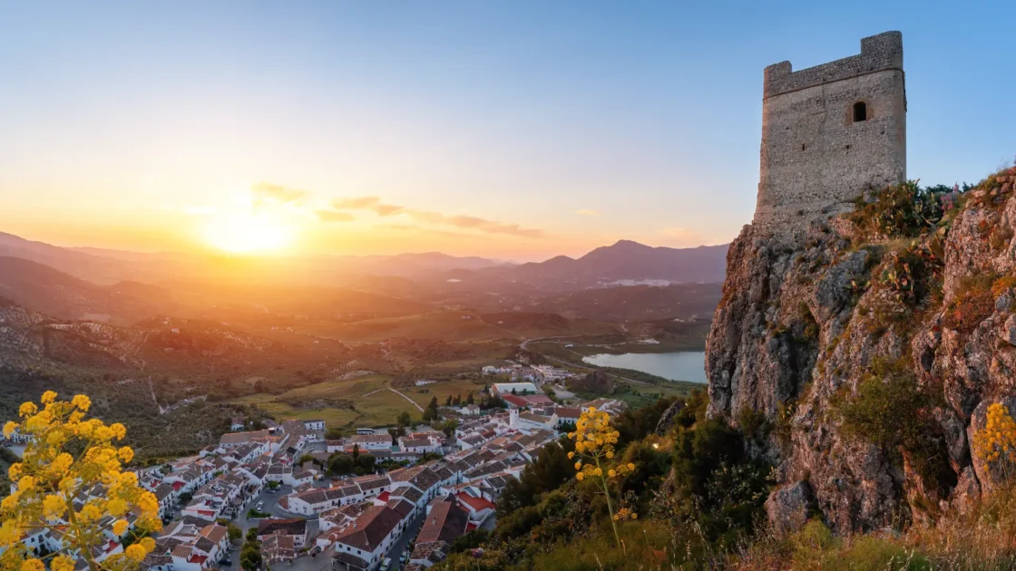 The castle keep of Zahara de la Sierra above its reservoir at sunset, Andalucía, Spain